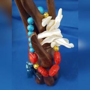Beach bracelet with coral, seashells, and turquouse beads, with tassel.